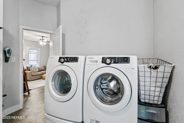 laundry area featuring hardwood / wood-style floors, washer and clothes dryer, and ceiling fan