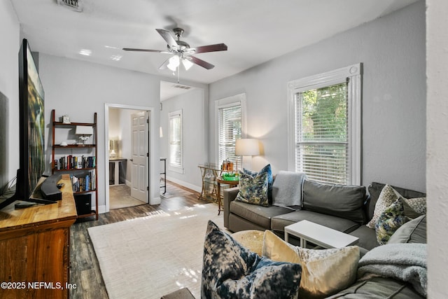 living room featuring hardwood / wood-style flooring and ceiling fan