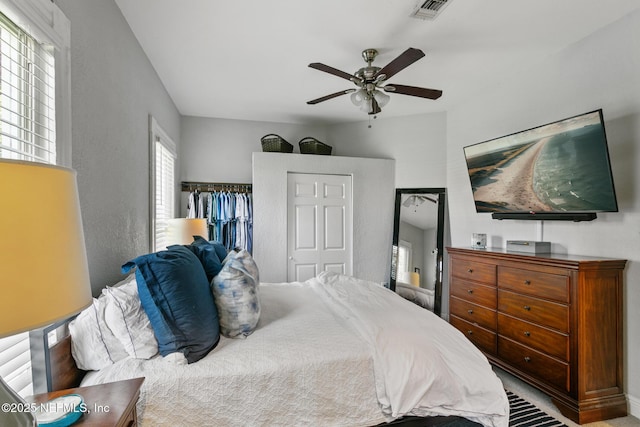 bedroom with ceiling fan and a closet