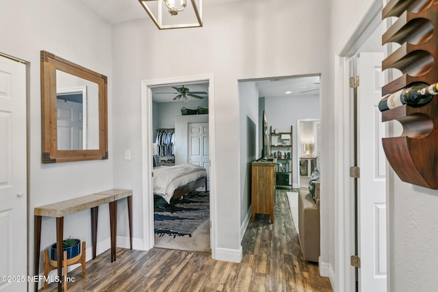 corridor with dark hardwood / wood-style flooring