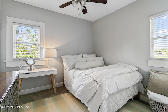 bedroom featuring dark colored carpet and ceiling fan