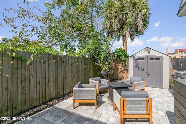 view of patio featuring a grill, an outdoor hangout area, and a storage unit