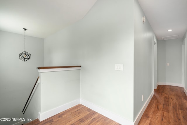 corridor with hardwood / wood-style floors