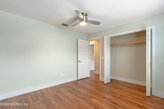 unfurnished bedroom featuring a closet, ceiling fan, and light wood-type flooring