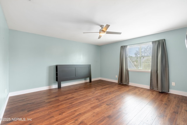 spare room with wood-type flooring and ceiling fan