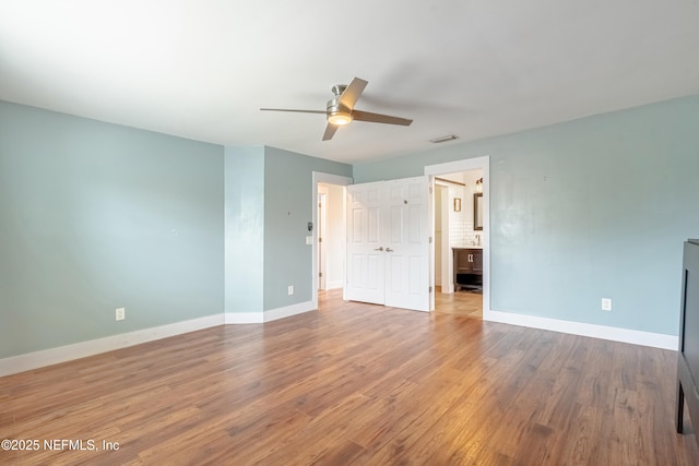 spare room featuring wood-type flooring and ceiling fan