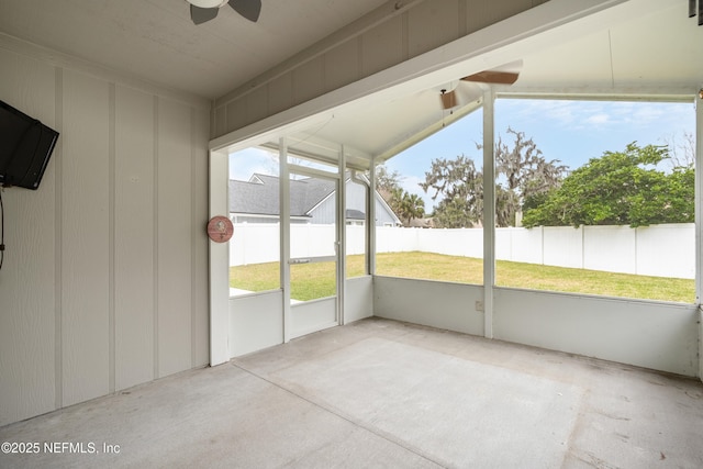 unfurnished sunroom featuring ceiling fan