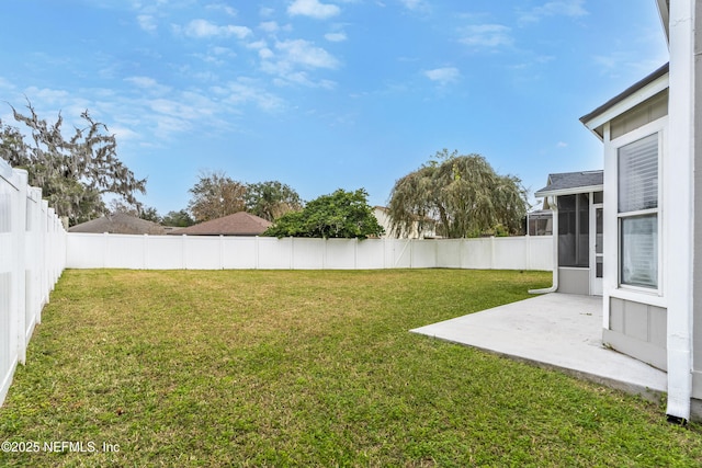 view of yard with a sunroom and a patio