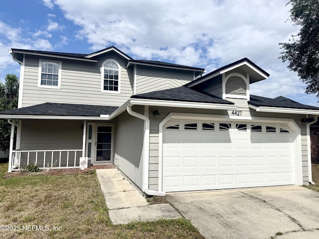 4427 Goodbys Hideaway Dr N, Jacksonville, FL 32217 - view of front of house featuring an attached garage, concrete driveway, roof with shingles, and a front yard