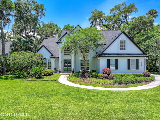 view of front of home with a front yard and french doors