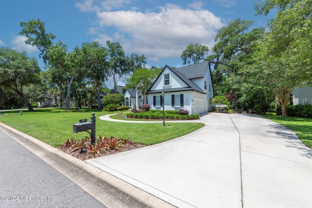 view of front of property featuring a front yard and a garage