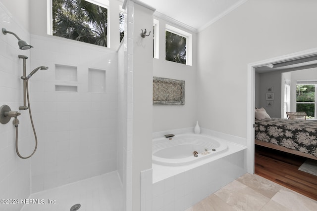 bathroom with independent shower and bath and crown molding