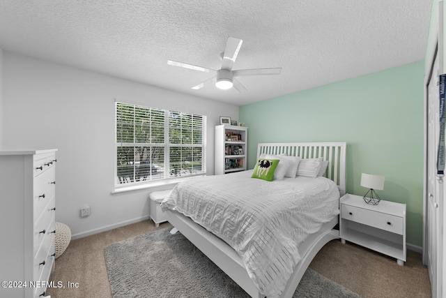 bedroom featuring carpet floors, ceiling fan, and a textured ceiling