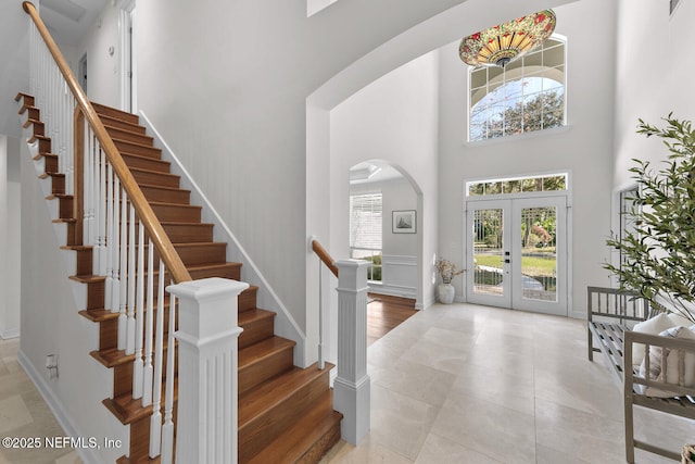 entrance foyer with a high ceiling and french doors