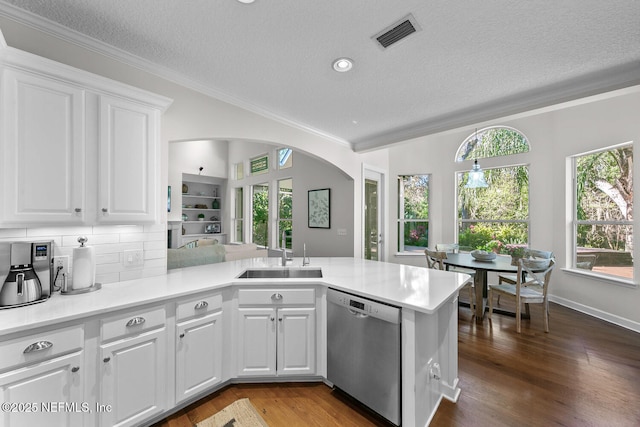 kitchen with sink, white cabinetry, tasteful backsplash, kitchen peninsula, and stainless steel dishwasher