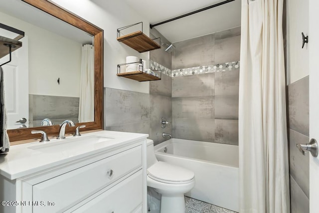 full bathroom with vanity, toilet, tile walls, and shower / bath combo