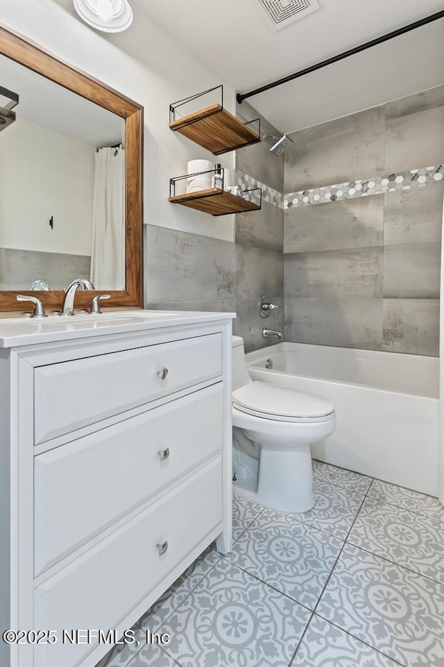 full bathroom featuring toilet, vanity, shower / tub combo, and tile patterned flooring