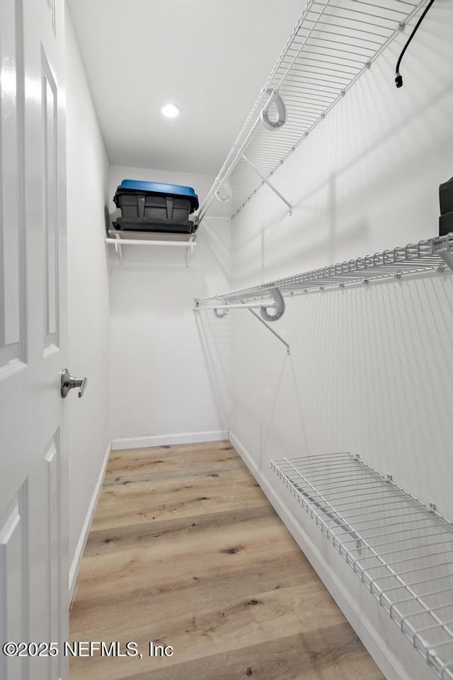 walk in closet featuring light hardwood / wood-style floors