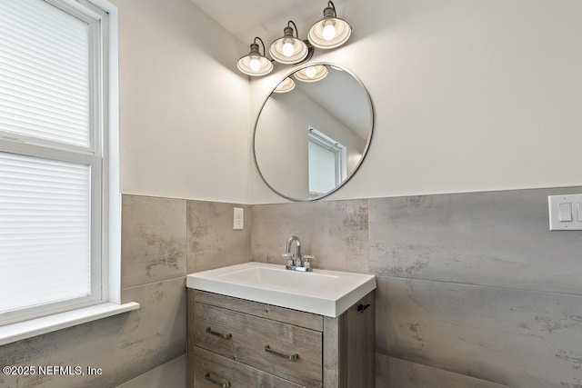 bathroom with vanity and tile walls