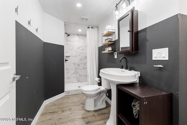 bathroom with sink, toilet, a shower with shower curtain, and wood-type flooring