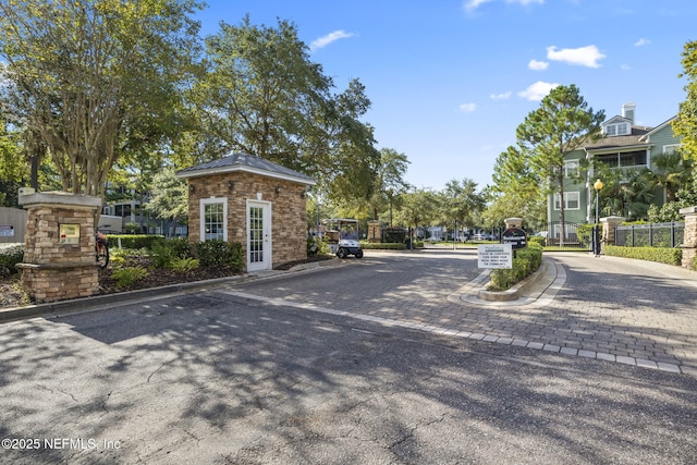 8550 Touchton Rd Unit 127, Jacksonville, FL 32216 - view of asphalt street featuring curbs, a gated entry, and street lights