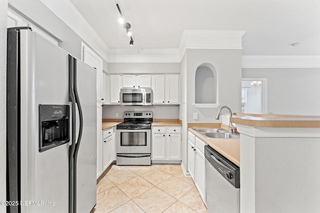 8550 Touchton Rd Unit 127, Jacksonville, FL 32216 - kitchen with appliances with stainless steel finishes, crown molding, light countertops, white cabinetry, and light tile patterned floors