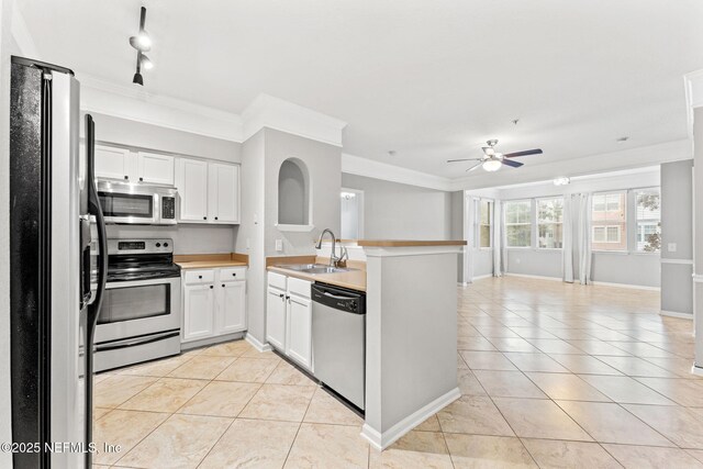 8550 Touchton Rd Unit 127, Jacksonville, FL 32216 - kitchen with a peninsula, stainless steel appliances, light tile patterned flooring, open floor plan, and ornamental molding