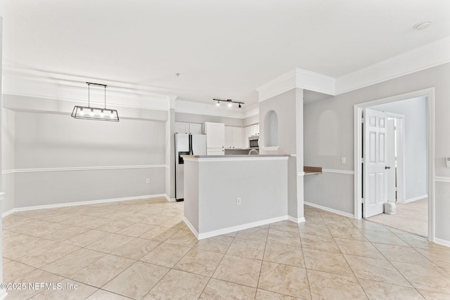 8550 Touchton Rd Unit 127, Jacksonville, FL 32216 - kitchen with white cabinets, fridge with ice dispenser, track lighting, ornamental molding, and a peninsula