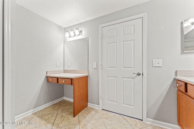 8550 Touchton Rd Unit 127, Jacksonville, FL 32216 - bathroom featuring vanity, a textured wall, and tile patterned floors