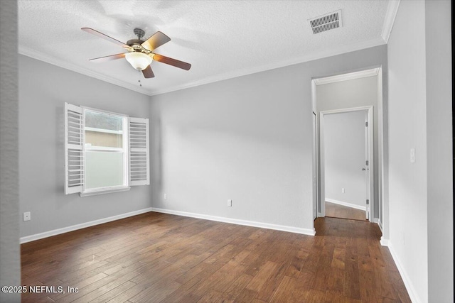 spare room with ceiling fan, dark hardwood / wood-style flooring, a textured ceiling, and crown molding