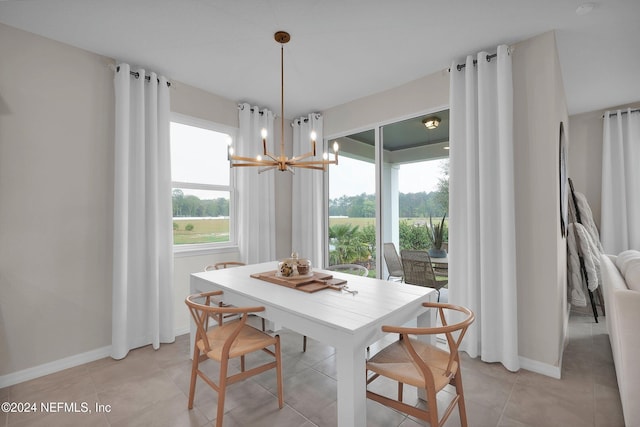 tiled dining space featuring a notable chandelier