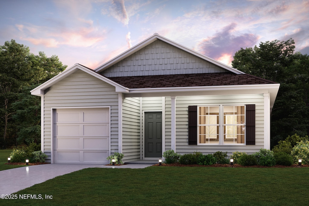 view of front facade featuring a garage and a yard