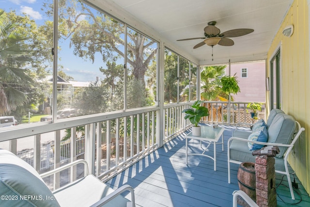 sunroom / solarium featuring ceiling fan and a wealth of natural light