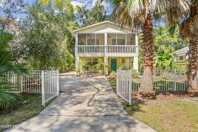 14 Ballard Ave, Saint Augustine, FL 32084 - view of front facade featuring a gate, driveway, a sunroom, and a fenced front yard