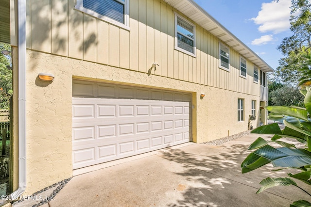 14 Ballard Ave, Saint Augustine, FL 32084 - view of side of property with a garage, driveway, and stucco siding