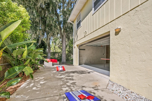 14 Ballard Ave, Saint Augustine, FL 32084 - view of patio featuring outdoor lounge area, an attached garage, and concrete driveway