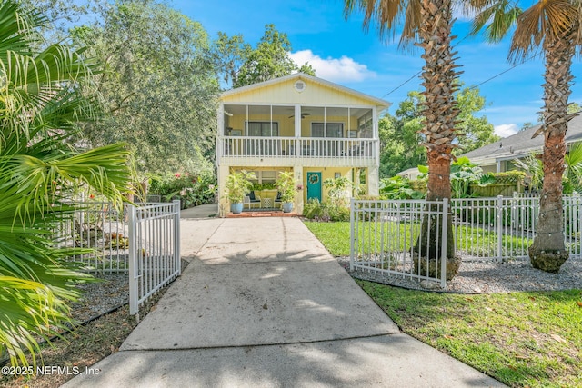 14 Ballard Ave, Saint Augustine, FL 32084 - view of front facade with a ceiling fan, a gate, a sunroom, and a fenced front yard