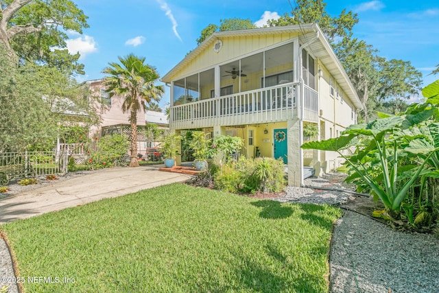 14 Ballard Ave, Saint Augustine, FL 32084 - rear view of property with a sunroom and a ceiling fan