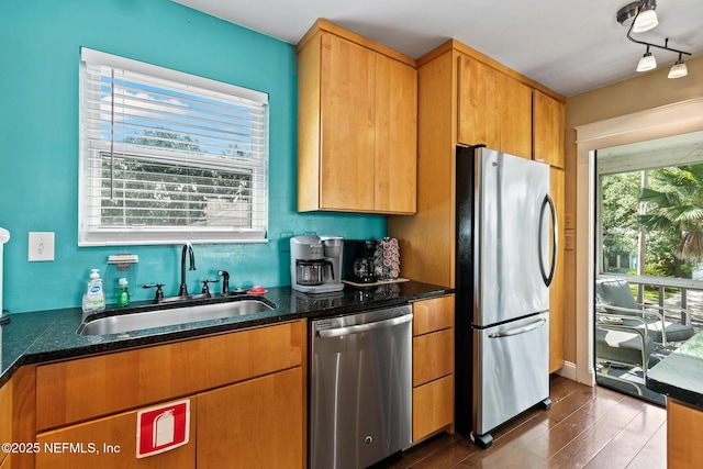 14 Ballard Ave, Saint Augustine, FL 32084 - kitchen with appliances with stainless steel finishes, dark wood-style floors, dark stone countertops, and rail lighting