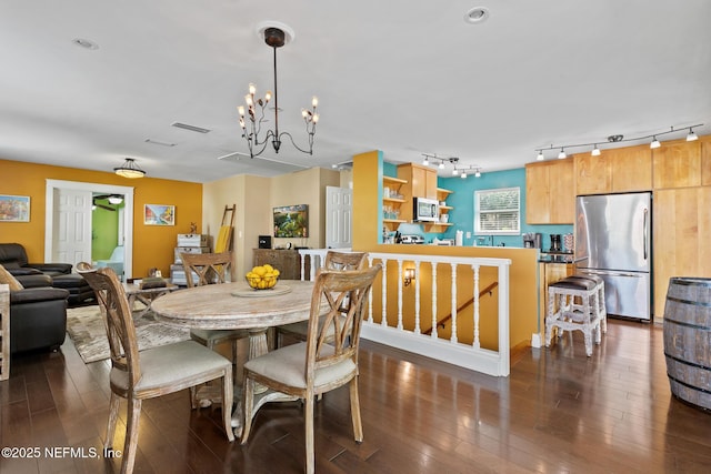 14 Ballard Ave, Saint Augustine, FL 32084 - dining space featuring rail lighting, dark wood-style floors, and a chandelier
