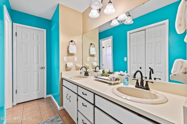 14 Ballard Ave, Saint Augustine, FL 32084 - full bathroom featuring double vanity, a closet, tile patterned flooring, and a chandelier