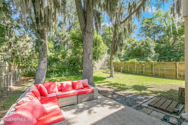14 Ballard Ave, Saint Augustine, FL 32084 - fenced backyard featuring an outdoor hangout area, a patio, and view of wooded area