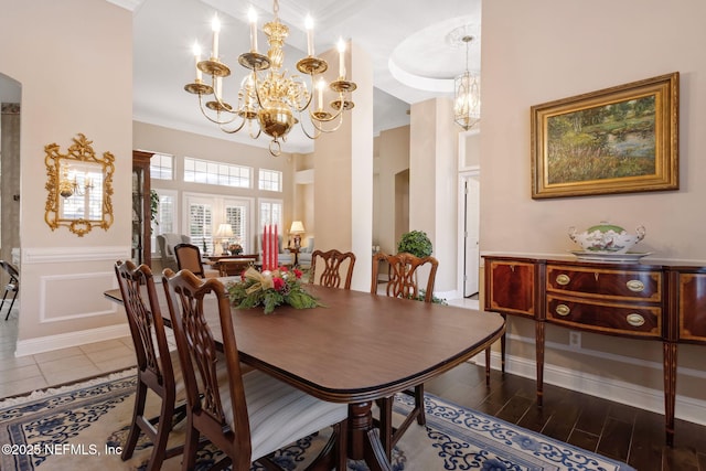 dining area with ornamental molding and a chandelier