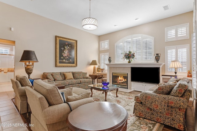 living room featuring light tile patterned floors and a tile fireplace