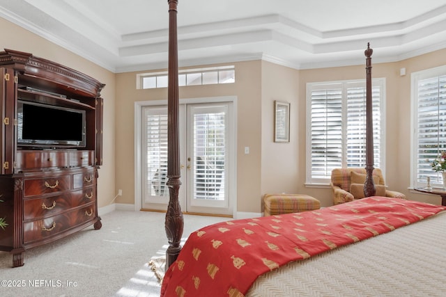 bedroom with light colored carpet, crown molding, a tray ceiling, and access to outside