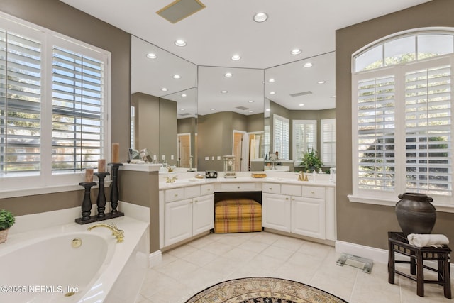 bathroom with a wealth of natural light, vanity, and tile patterned flooring