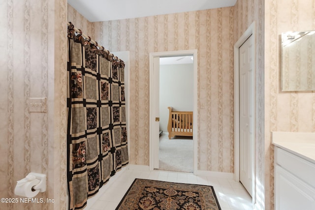 bathroom with walk in shower, vanity, and tile patterned floors