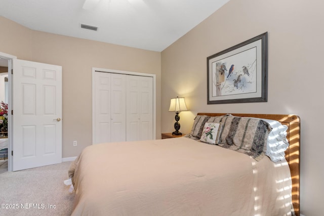 carpeted bedroom with ceiling fan and a closet