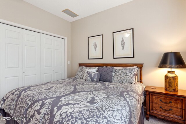 carpeted bedroom with a closet