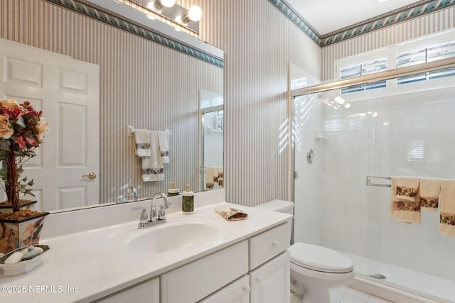 bathroom with a shower with shower door, vanity, and toilet